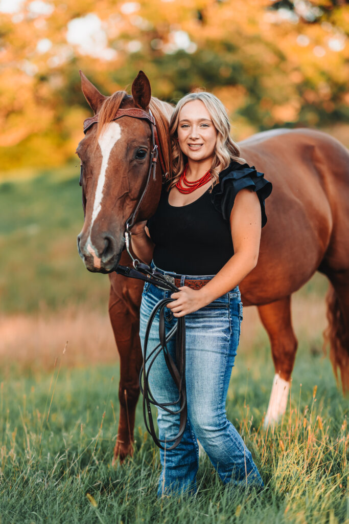 High school girl posing with her horse during her senior session.