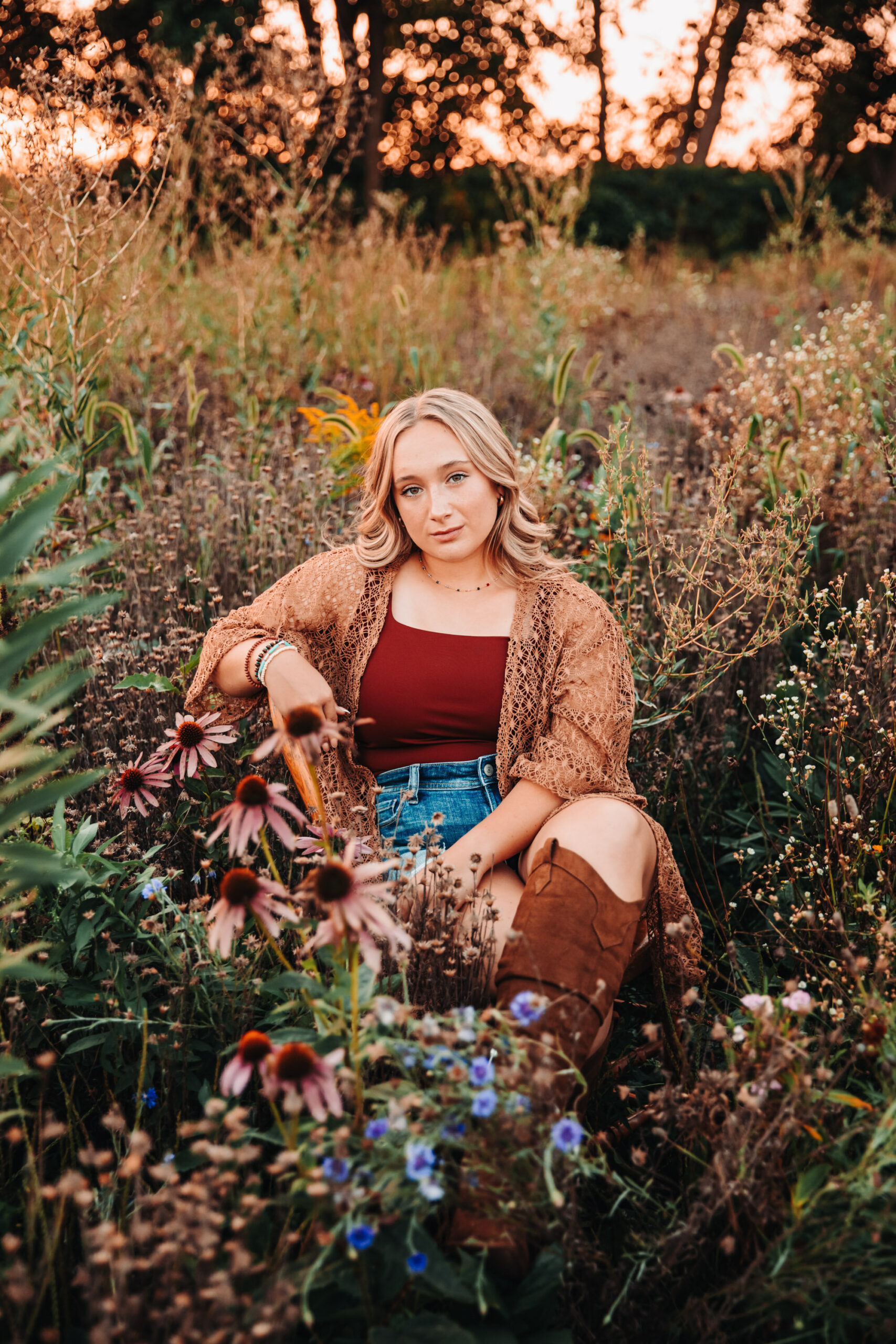 Darlington high school senior sitting in a wild flower field in Wisconsin