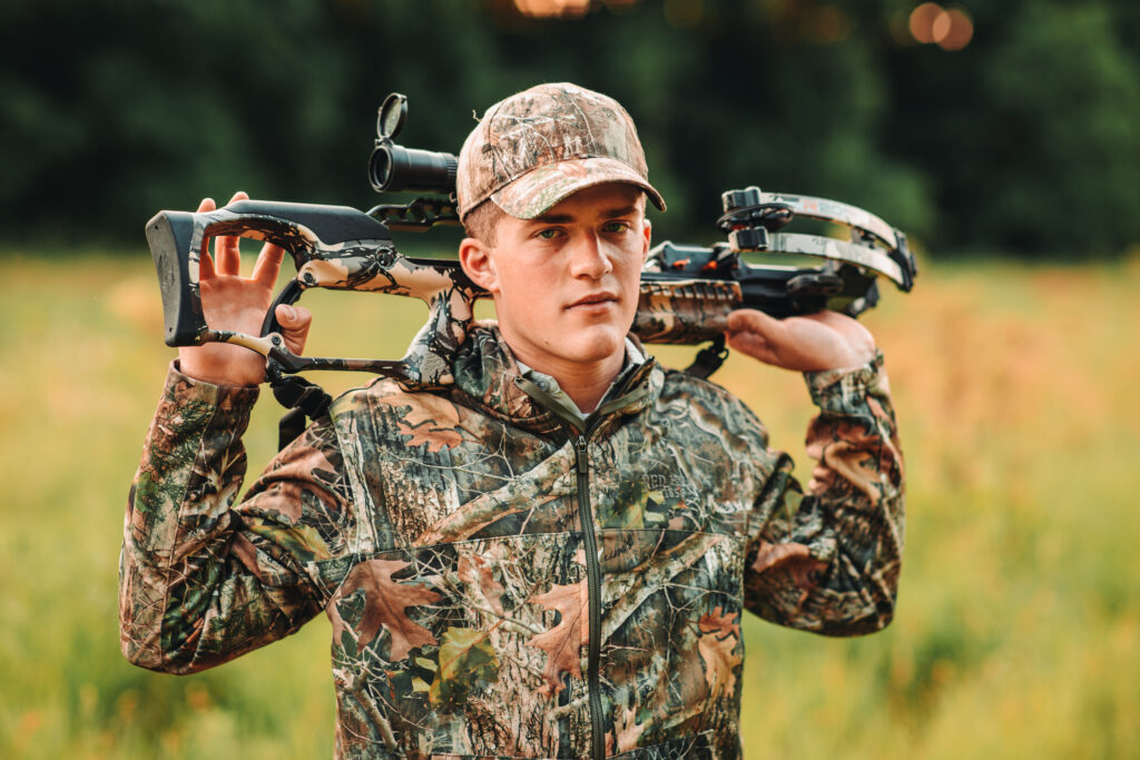 Darlington high school senior posing with his hunting equipment in Wisconsin