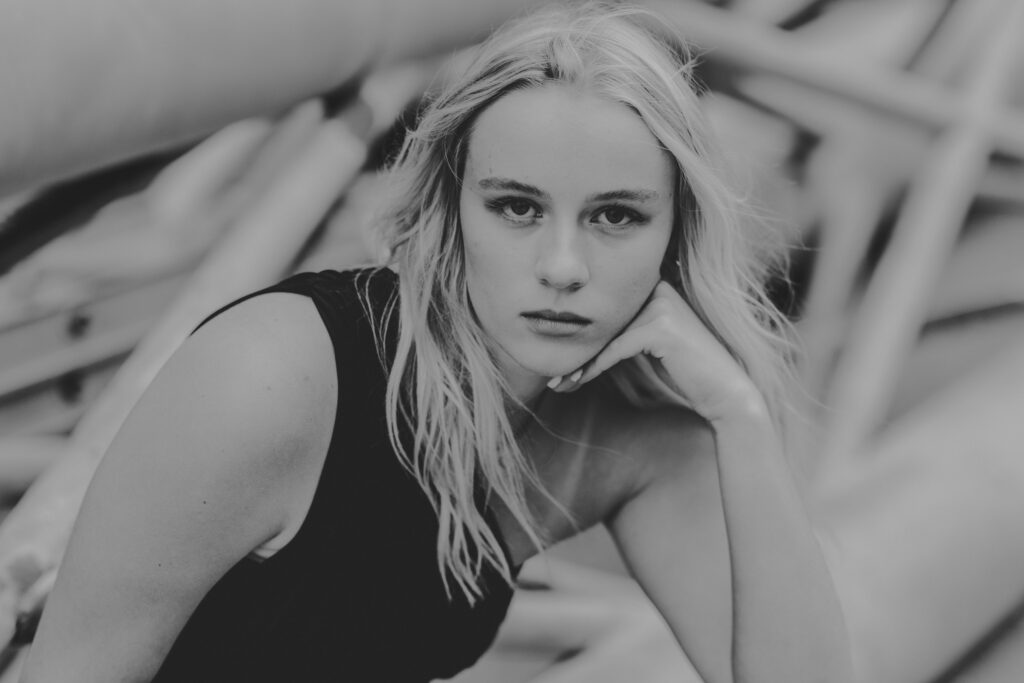 high school senior girl posing with a sultry look in black and white images