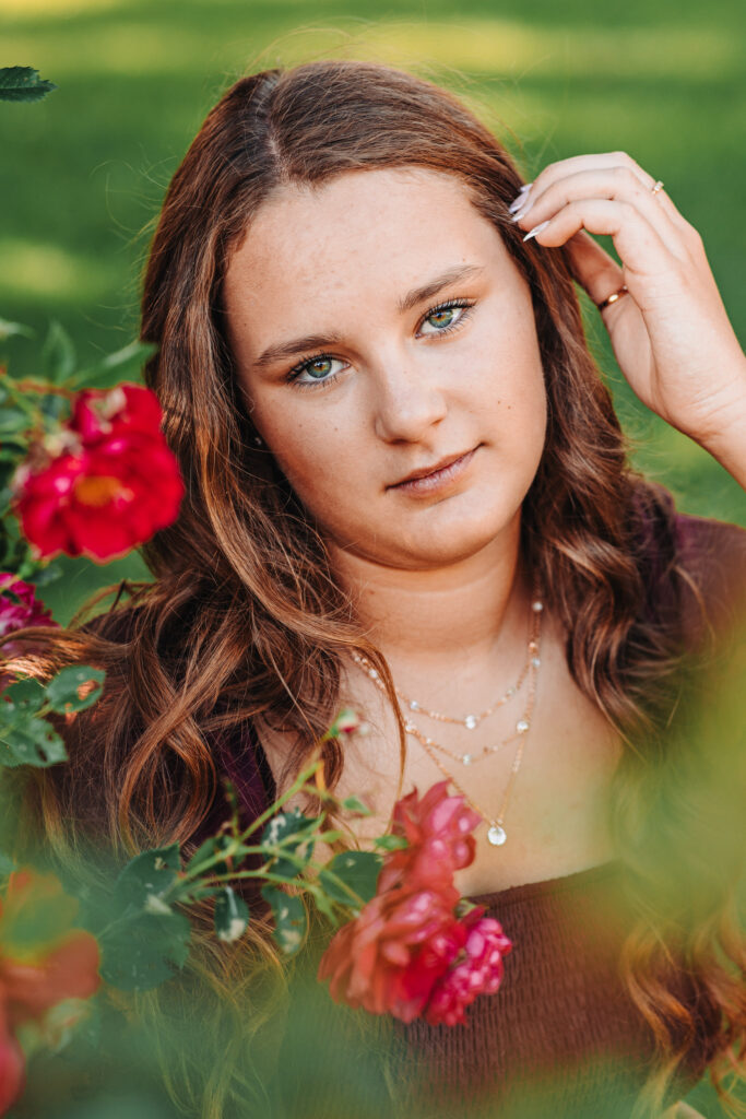 Megan in her Western outfit with a beautiful rosebush trellis background