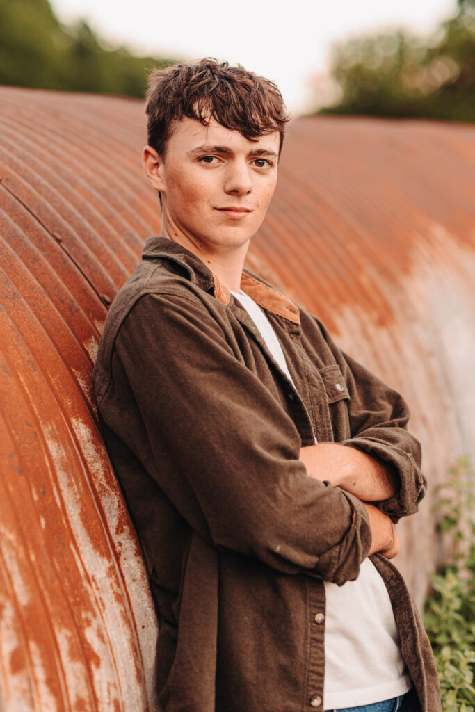 Ian standing next to old road tubes, capturing rustic charm