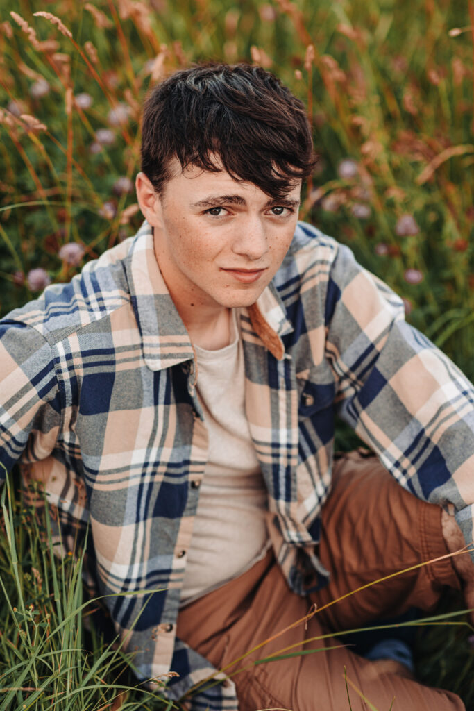 High school senior Ian in a flannel shirt, posing naturally