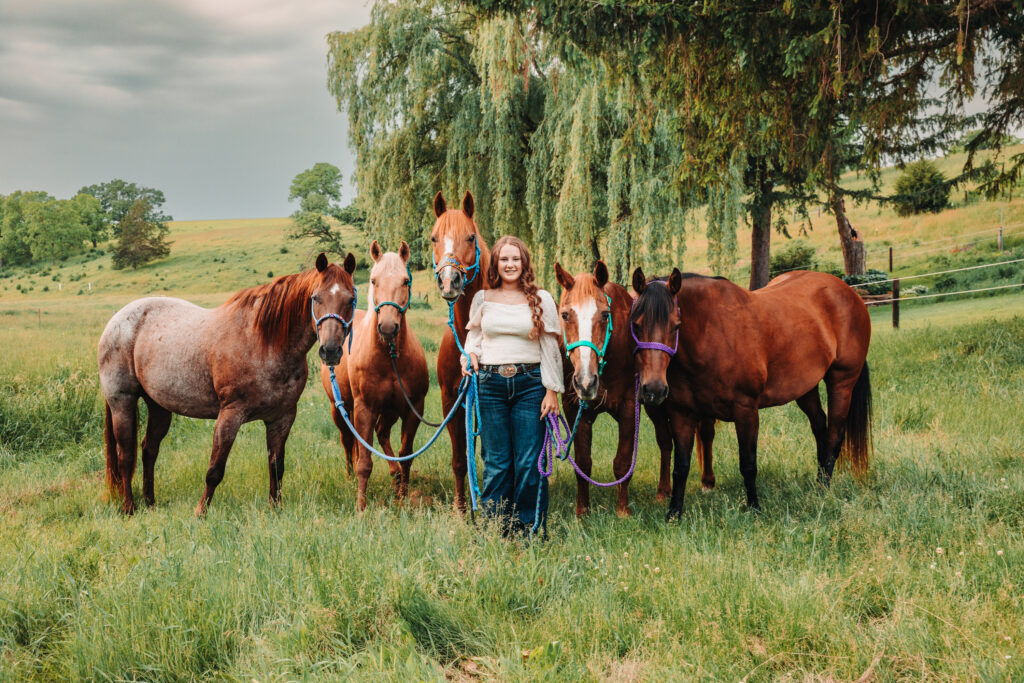 Megan in her Western outfit with a beautiful rosebush trellis background