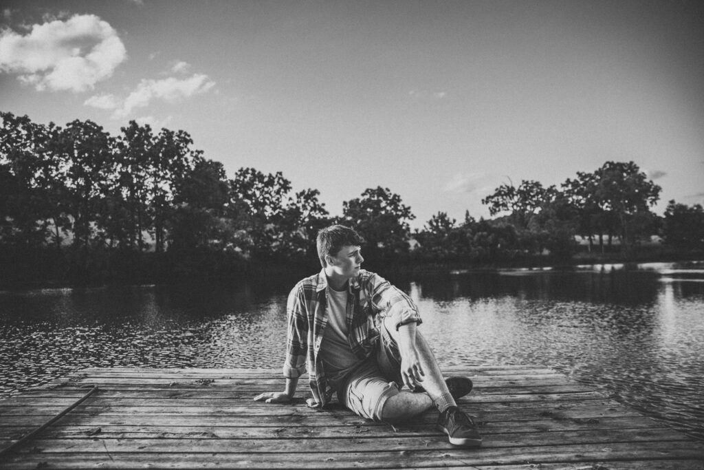 Ian Wacker standing on the dock during his senior photo session