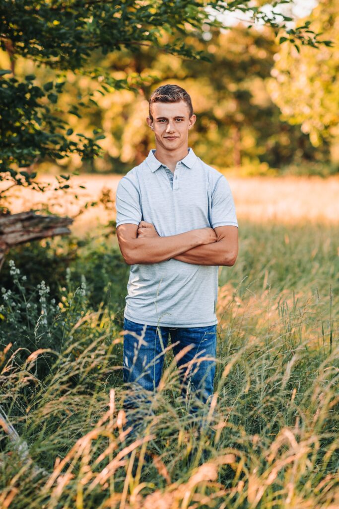 Belmont Wisconsin high school senior guy standing in a tall grassy field